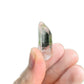 Hand-held view of a single Lemurian Quartz raw point from Colombia.