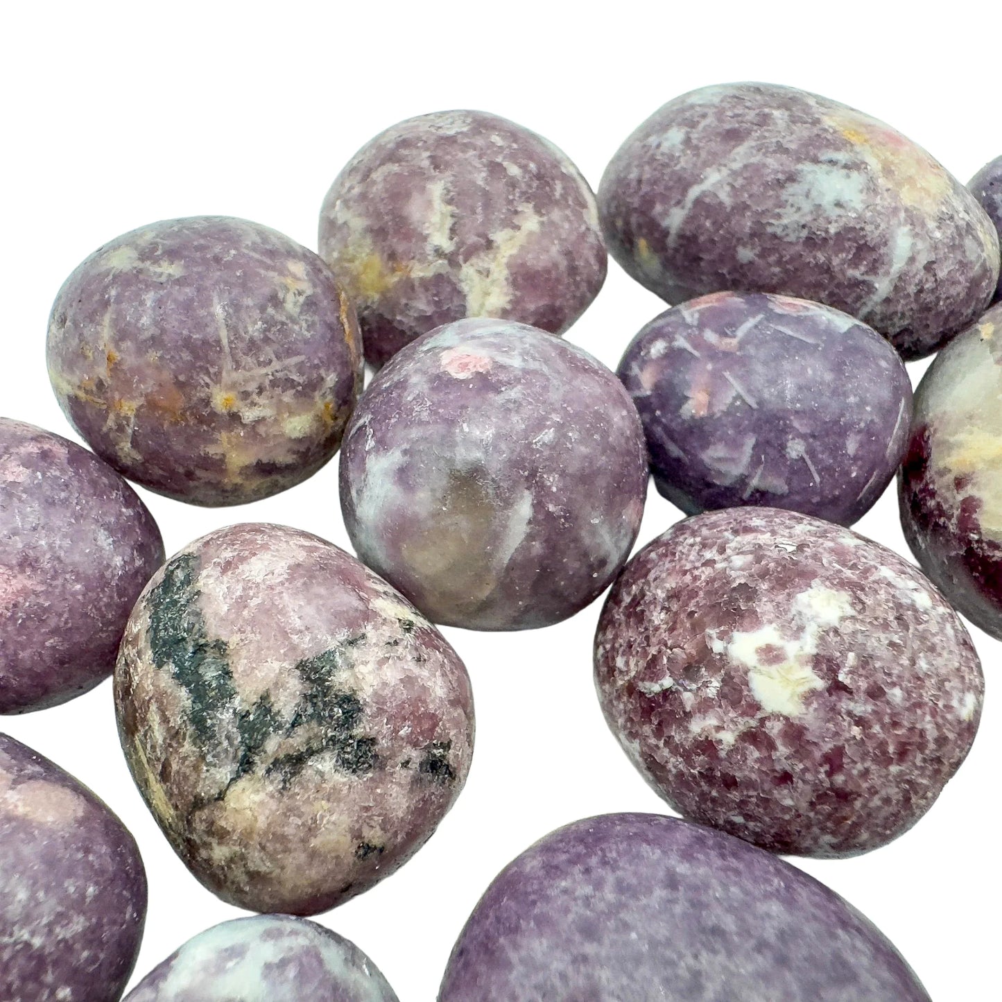 Underside detail of purple Lepidolite tumbled stone, linked to Stress Relief, showing characteristic finish.