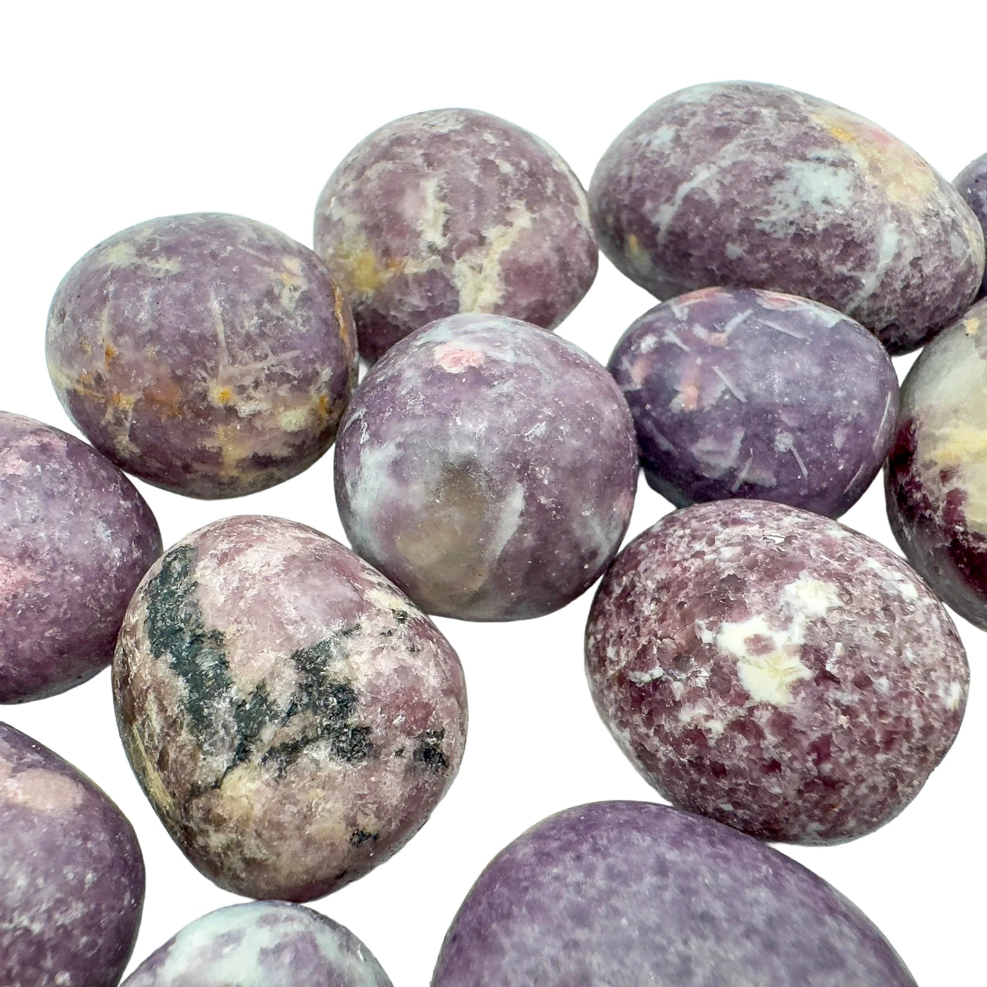 Underside detail of purple Lepidolite tumbled stone, linked to Stress Relief, showing characteristic finish.