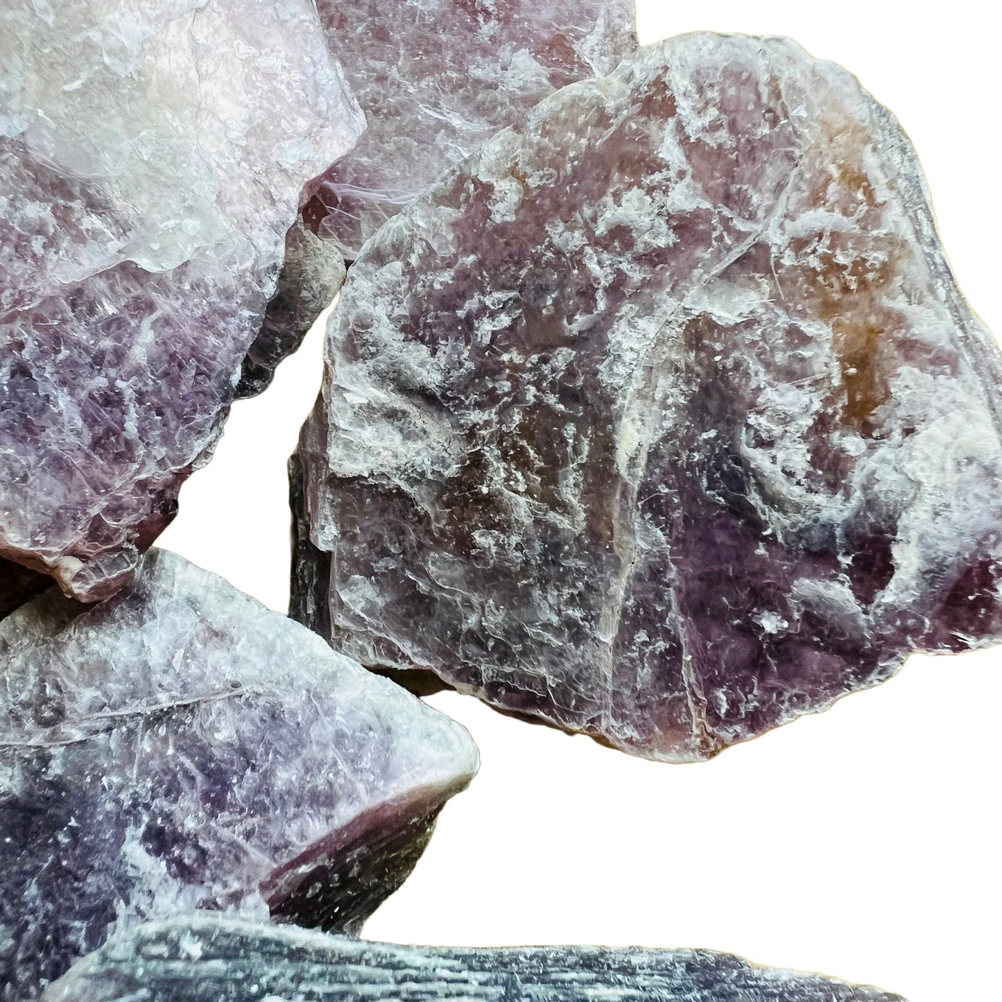 In-hand view of a single Lepidolite raw stone sourced from Brazil.