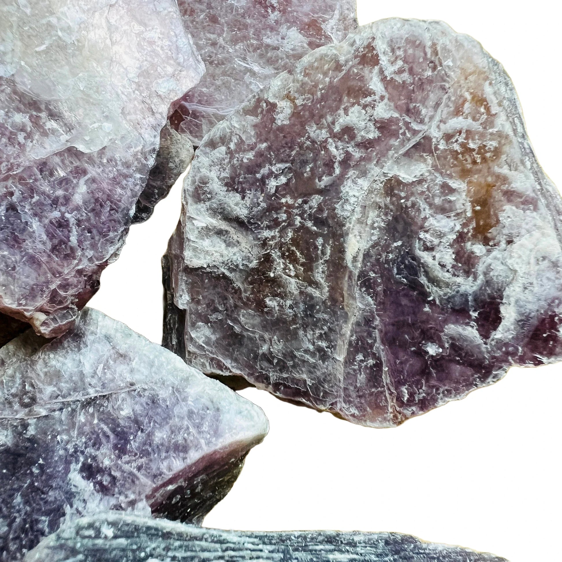 In-hand view of a single Lepidolite raw stone sourced from Brazil.