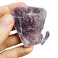 Grade aa lepidolite raw held in hand for size reference