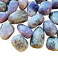 Magnified detail of Lepidolite tumbled stone, showing glassy finish, linked to Stress Relief.