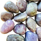 Side angle of Grade A Lepidolite tumbled stone, showing natural texture.