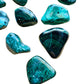 Detail shot of Grade AA Malachite tumbled stone under natural light