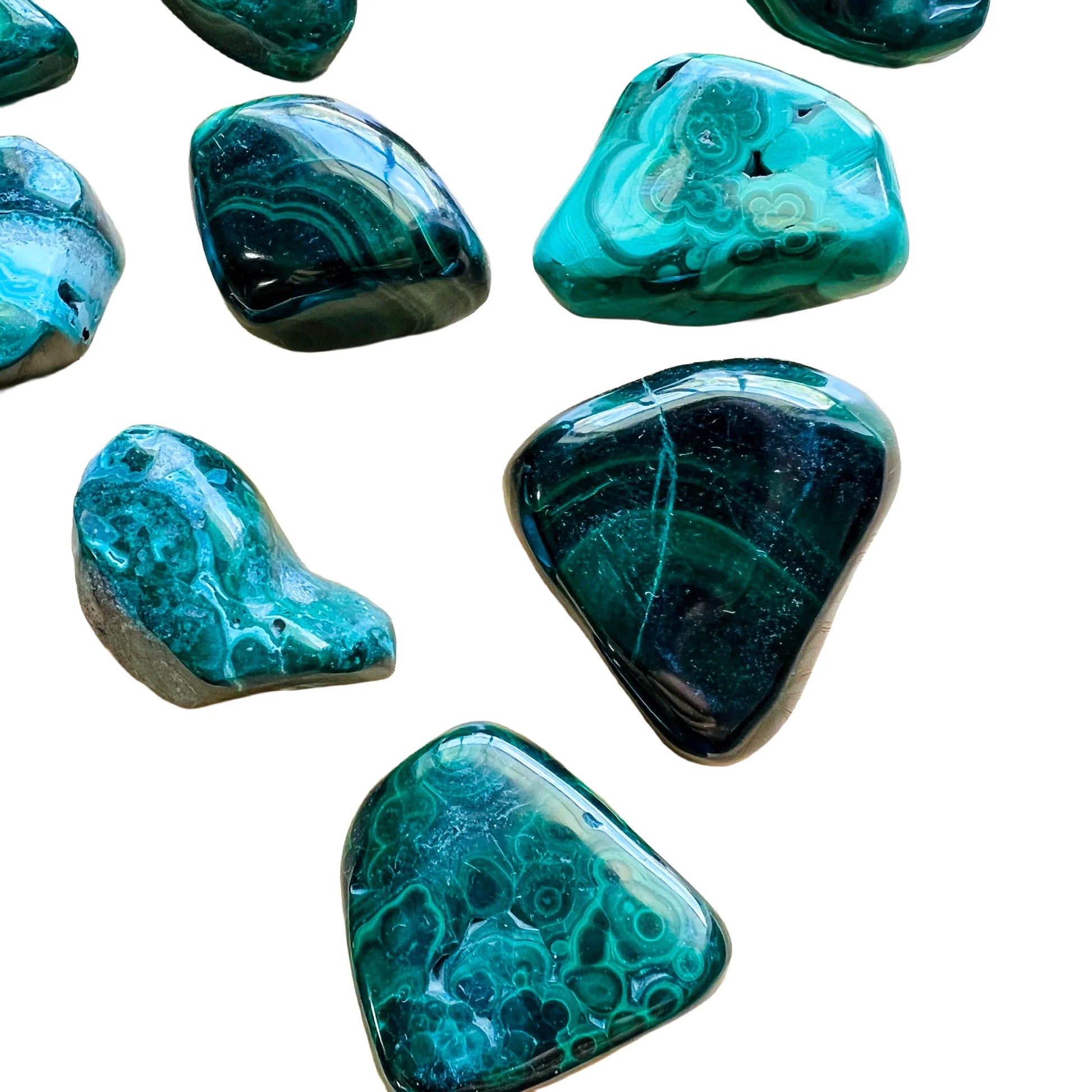 Detail shot of Grade AA Malachite tumbled stone under natural light