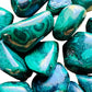 Overhead angle of Grade AA Malachite tumbled stone, for Emotional Healing, showing color depth.
