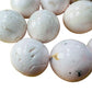 Edge view of Grade AAA Mangano Calcite tumbled stone, kept near for Emotional Healing.