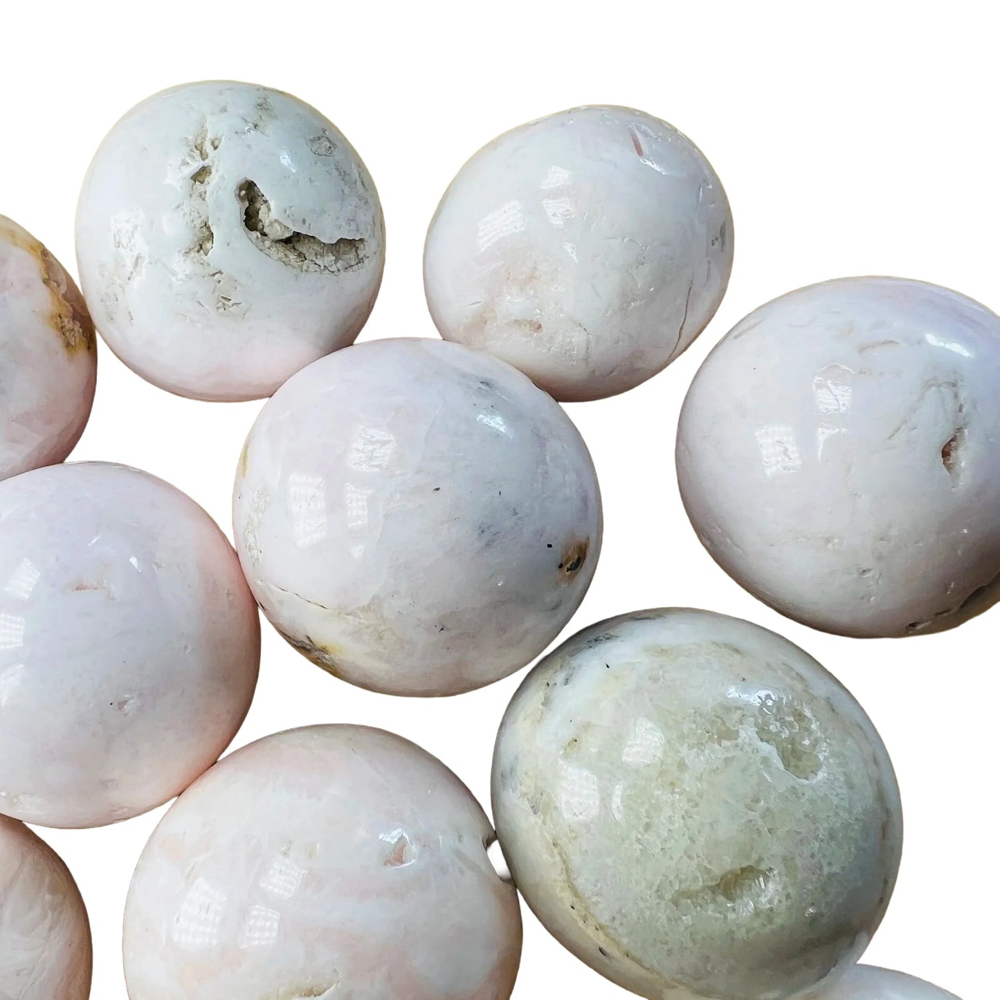 Size comparison with a Mangano Calcite tumbled stone to support Emotional Healing and Self Love, Peru-sourced.