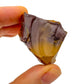 Hand-scale shot of a single Mookaite raw stone hand-selected from Western Australia, Australia.
