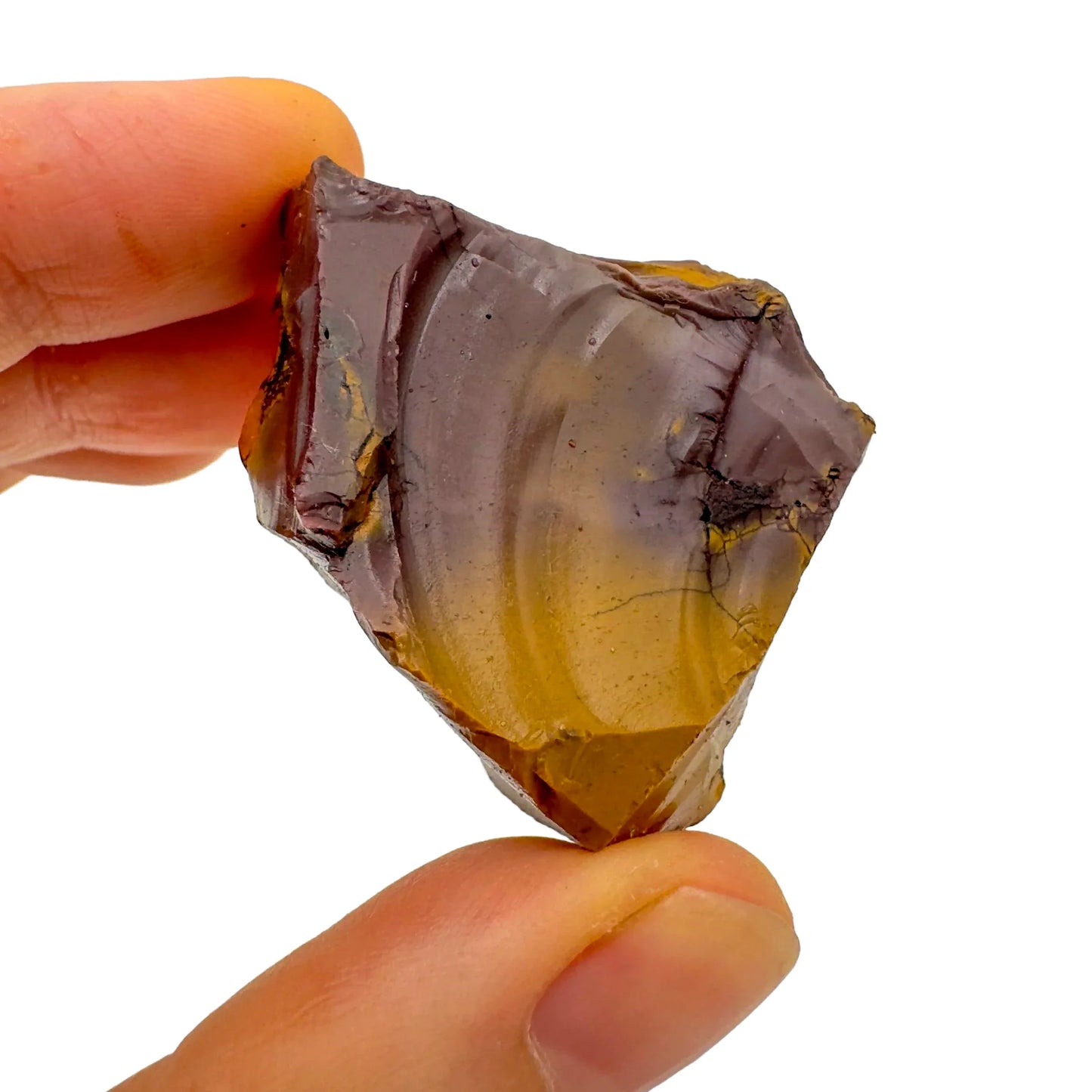 Hand-scale shot of a single Mookaite raw stone hand-selected from Western Australia, Australia.