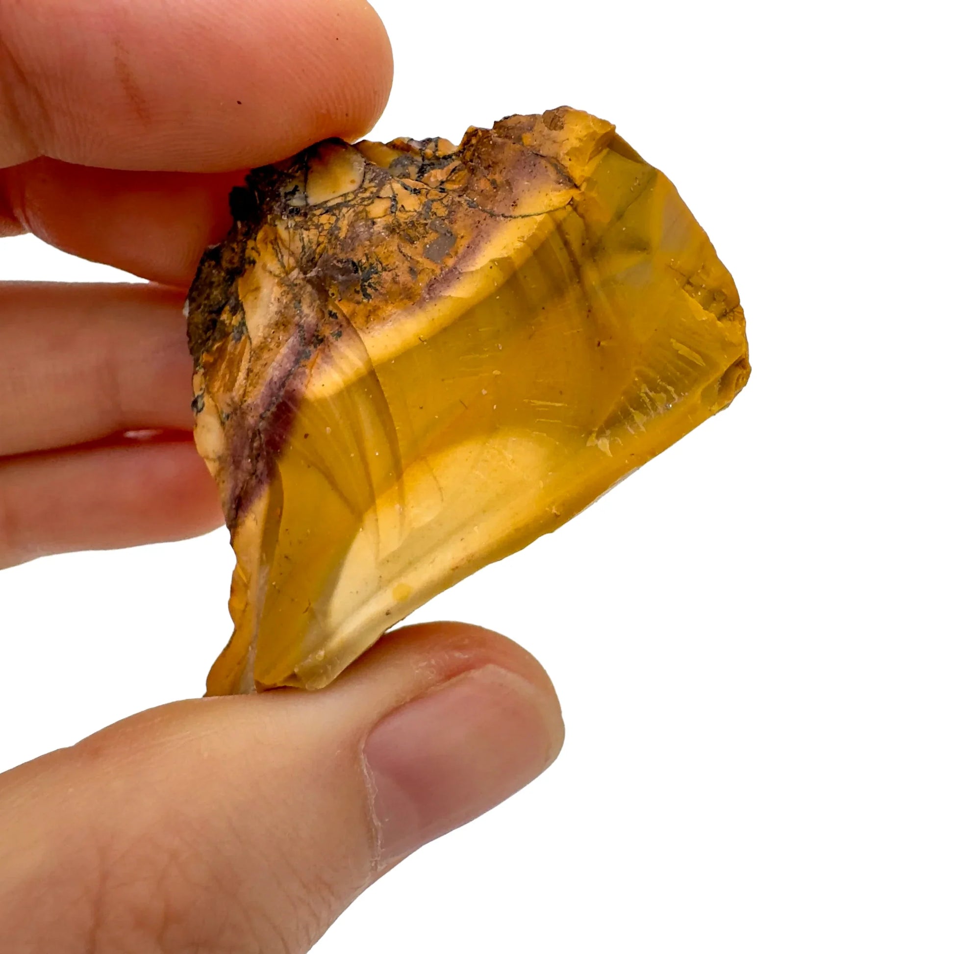 Hand-scale view of Mookaite stone, associated with Adventure, shown alongside the hand for scale.