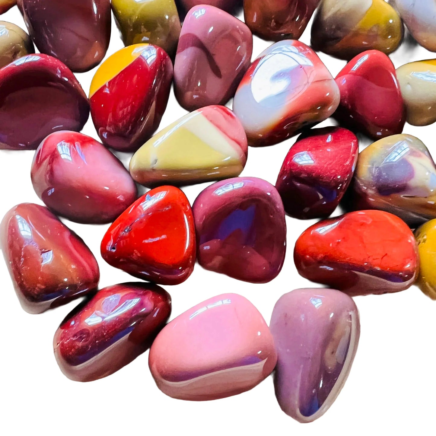 Held in hand, a Mookaite tumbled stone carried for Grounding.