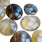 Overhead angle of Grade A Natural Citrine palm stone, Madagascar-sourced, showing color depth.