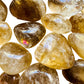 Magnified detail of Natural Citrine tumbled stone, sourced from Minas Gerais, Brazil, often paired with practices around Abundance.