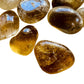 Side perspective of Natural Citrine tumbled stone, sourced from Minas Gerais, Brazil, showing natural texture.