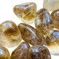 Size comparison with a single Natural Citrine tumbled stone Brazil-sourced, Brazil-sourced.