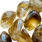 Macro view of Natural Citrine tumbled stone, Brazil-sourced, showing natural variation.