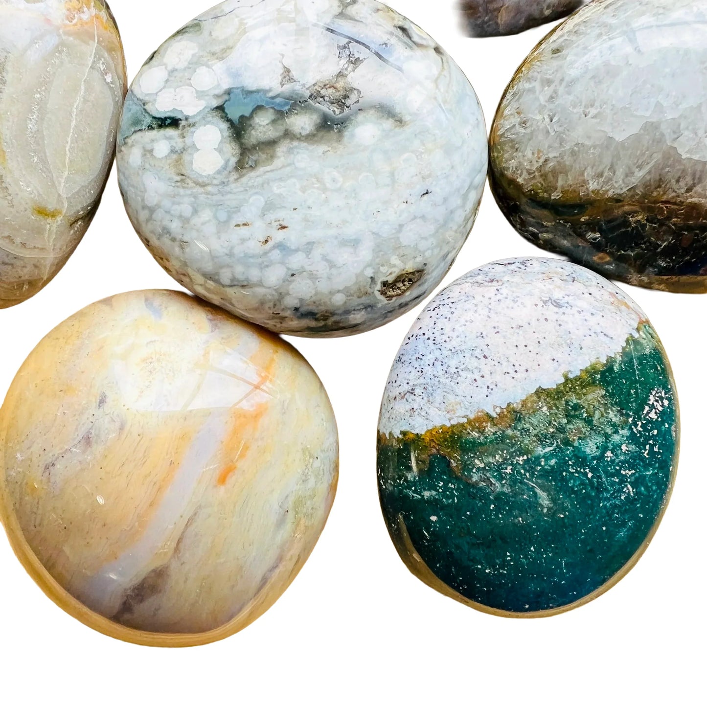 Close-up of Grade AA Ocean Jasper palm stone, from Sofia, Madagascar, kept near for Emotional Healing and Stress Relief.