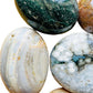 Lateral view of Ocean Jasper palm stone, hand-selected from Sofia, Madagascar, showing natural texture.