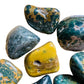 Lateral view of Ocean Jasper tumbled stone, showing natural sheen.