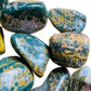 Scale reference of one Ocean Jasper tumbled stone for scale, sourced from Sofia, Madagascar.
