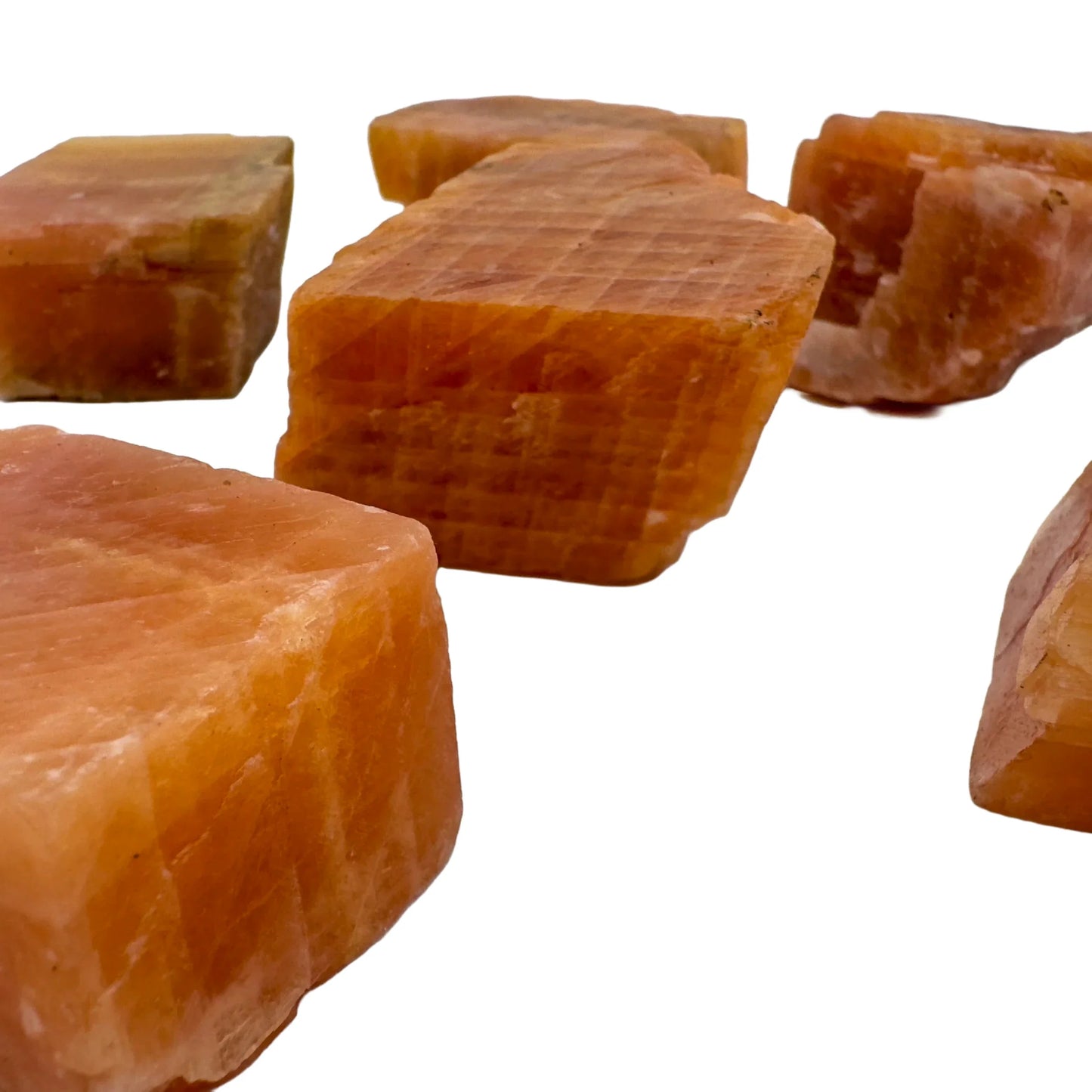 Side profile of Orange Calcite raw stone, sourced from Erongo, Namibia, showing natural texture.