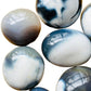 Side profile of Orca Agate palm stone, showing subtle veining.