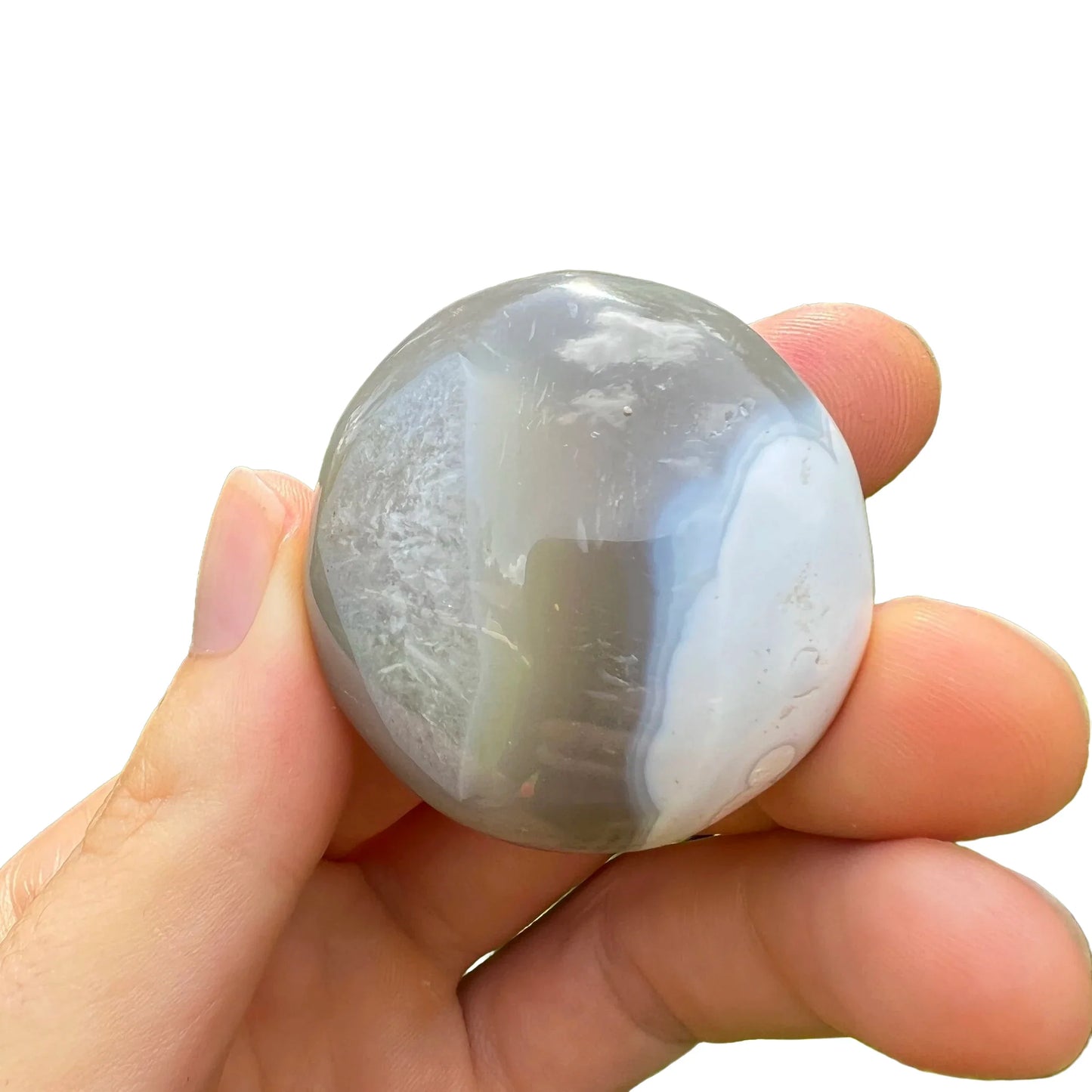 Scale reference of a single Orca Agate palm stone Madagascar-sourced.
