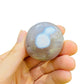 Detail shot of Grade AA Orca Agate palm stone under natural light