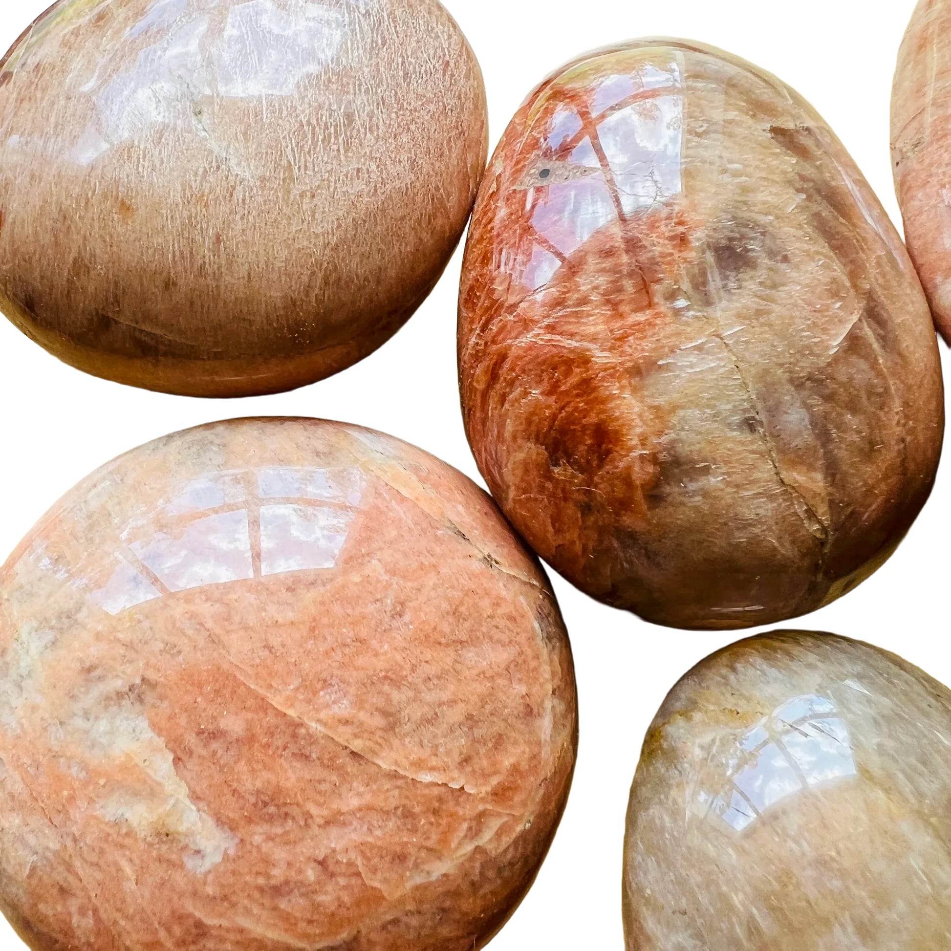Profile view of Peach Moonstone palm stone, showing translucent edges, turned to for Emotional Healing.