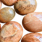Bird's-eye view of Grade AA Peach Moonstone palm stone, traditionally used for Emotional Healing.
