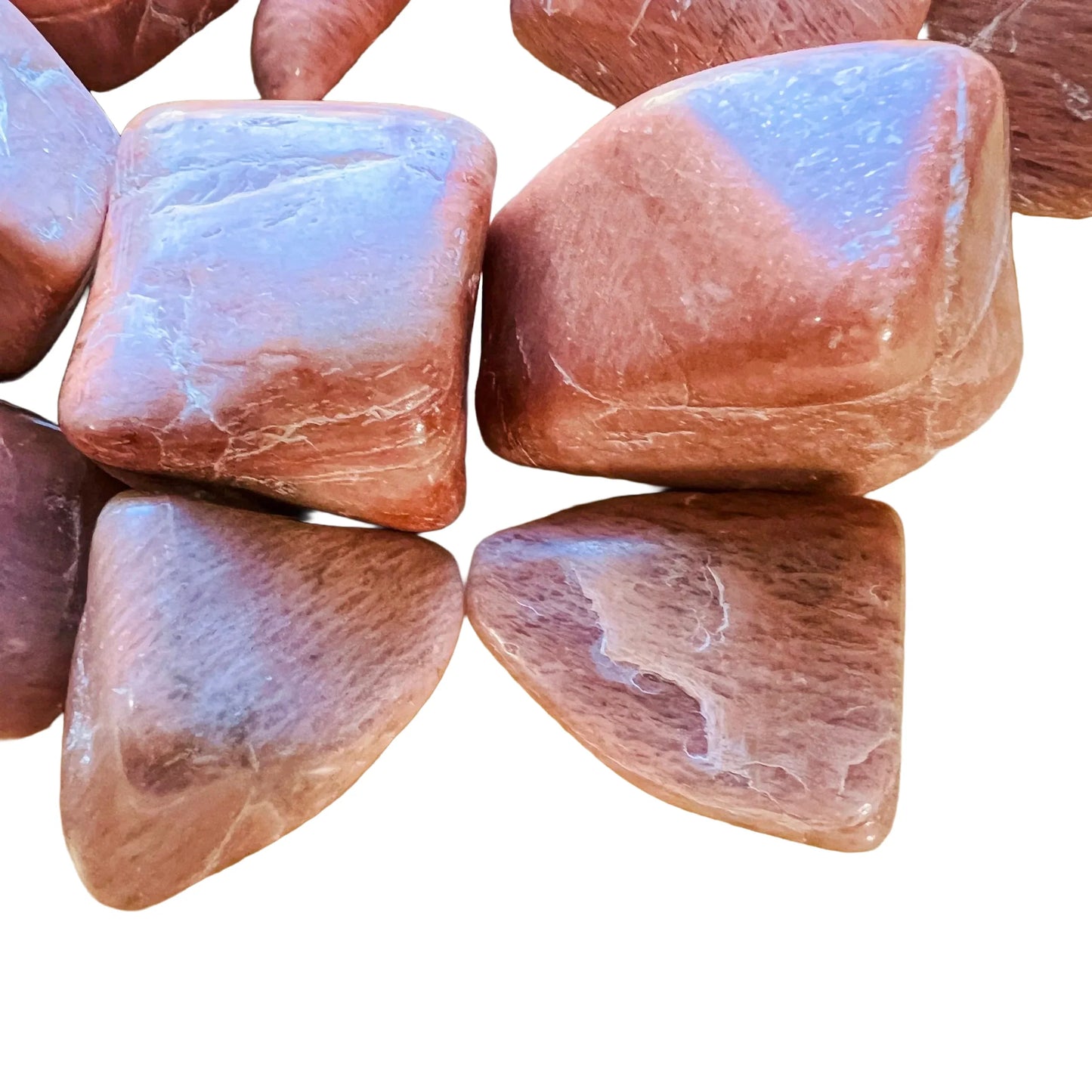 Edge view of Peach Moonstone tumbled stone, often kept for Emotional Healing and Self Love.