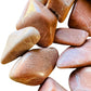 Bird's-eye view of Peach Moonstone tumbled stone, linked to Emotional Healing, sourced from Madagascar.