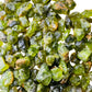 Daylight view of a Peridot raw stone carried for Abundance.