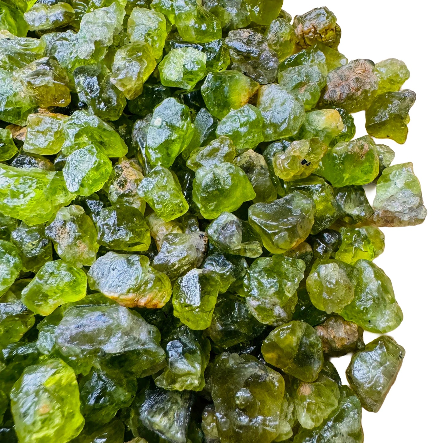 Underside view of green Peridot raw stone, showing characteristic color.