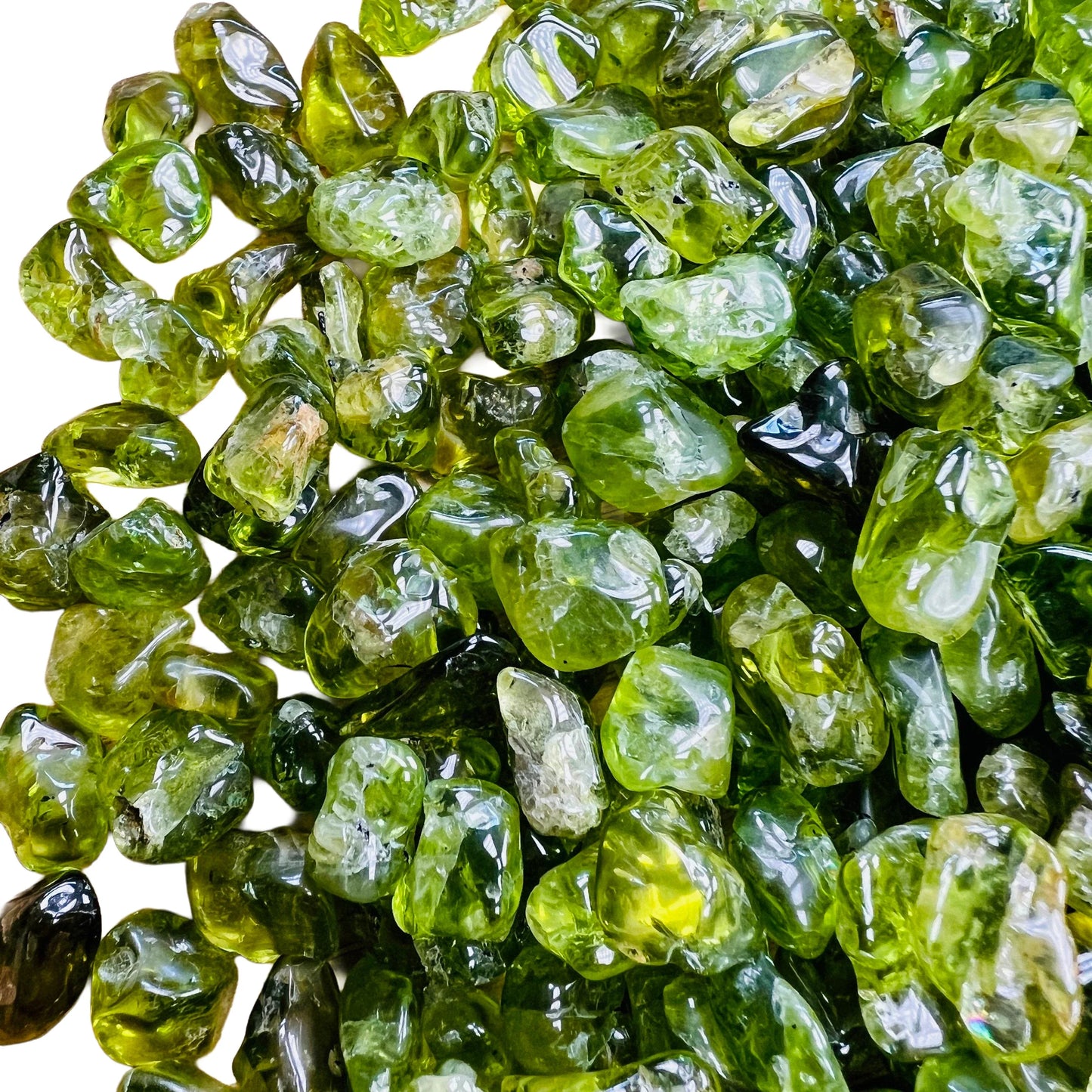 Sideways view of green Peridot tumbled stone, carried for Abundance and Emotional Healing, hand-selected from San Carlos Apache.