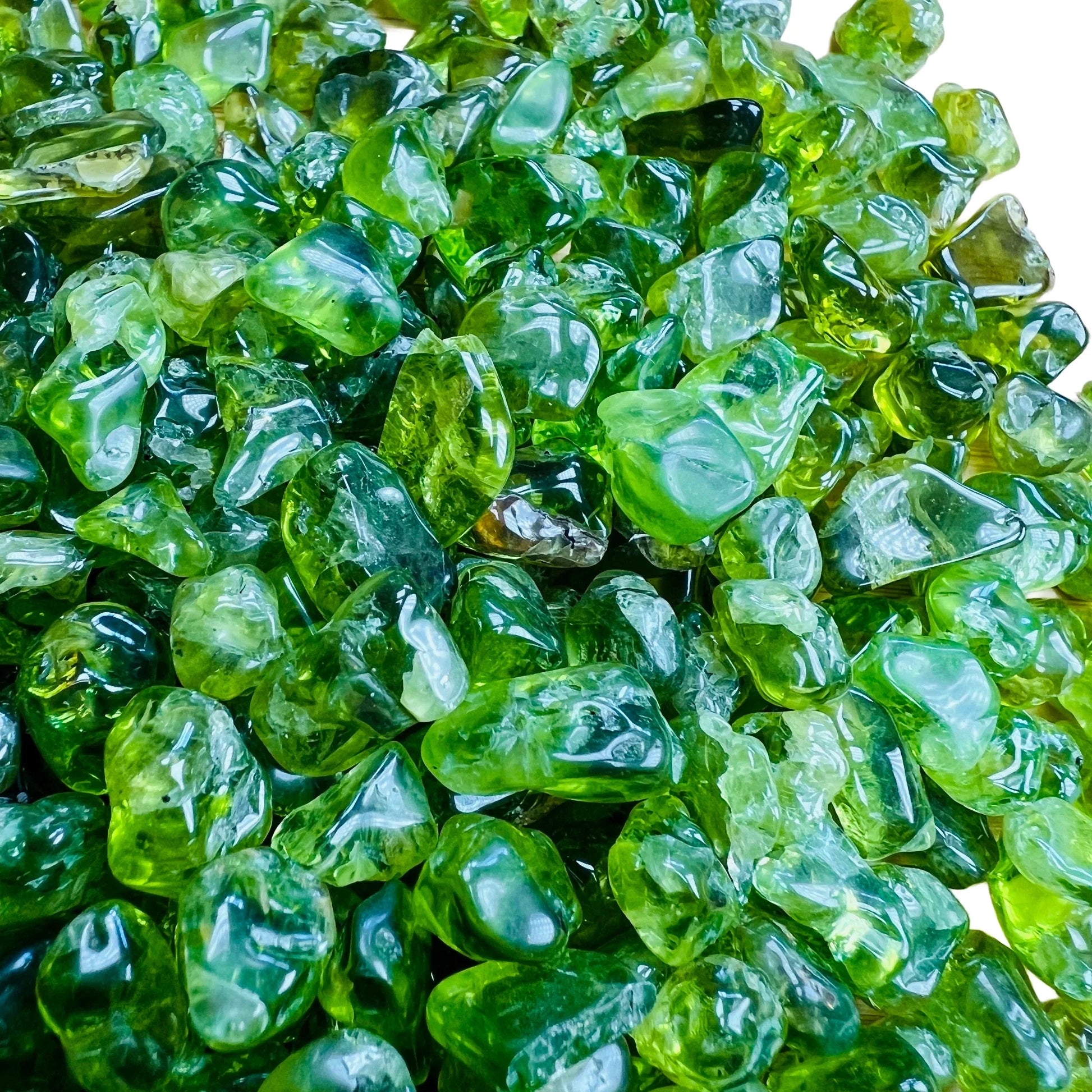 Rear view of Grade AA Peridot tumbled stone, linked to Abundance.