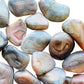Bird's-eye view of Pink Agate tumbled stone, sourced from Botswana, often worked with for Love.