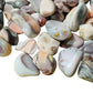 Side perspective of Pink Agate tumbled stone, showing natural texture, drawn on for Love.