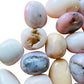 Top-side view of Grade A Pink Opal tumbled stone, from Ica, Peru, showing translucent edges.