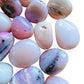 Rear view of Grade A Pink Opal tumbled stone, from Ica, Peru.