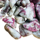 Detail shot showing Pink Tourmaline tumbled stone, Madagascar-sourced, associated with Love.