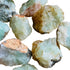 Alternate angle of green Prehnite raw stone, showing characteristic finish, from Kunene, Namibia.