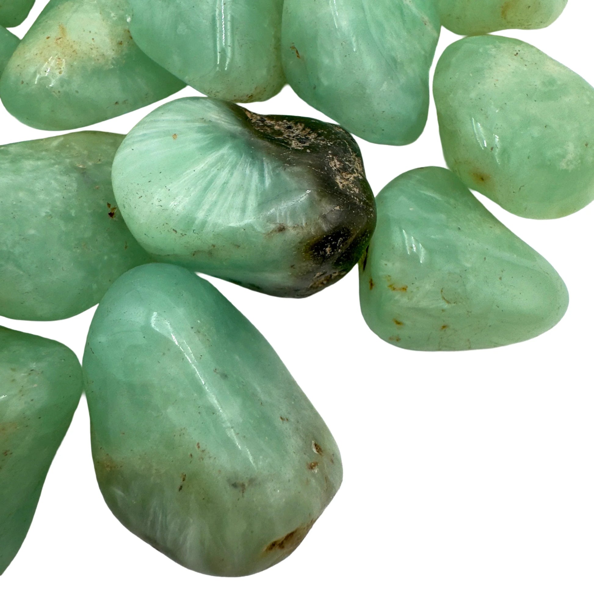 Profile shot of Prehnite tumbled stone, sourced from Namibia, showing natural sheen.