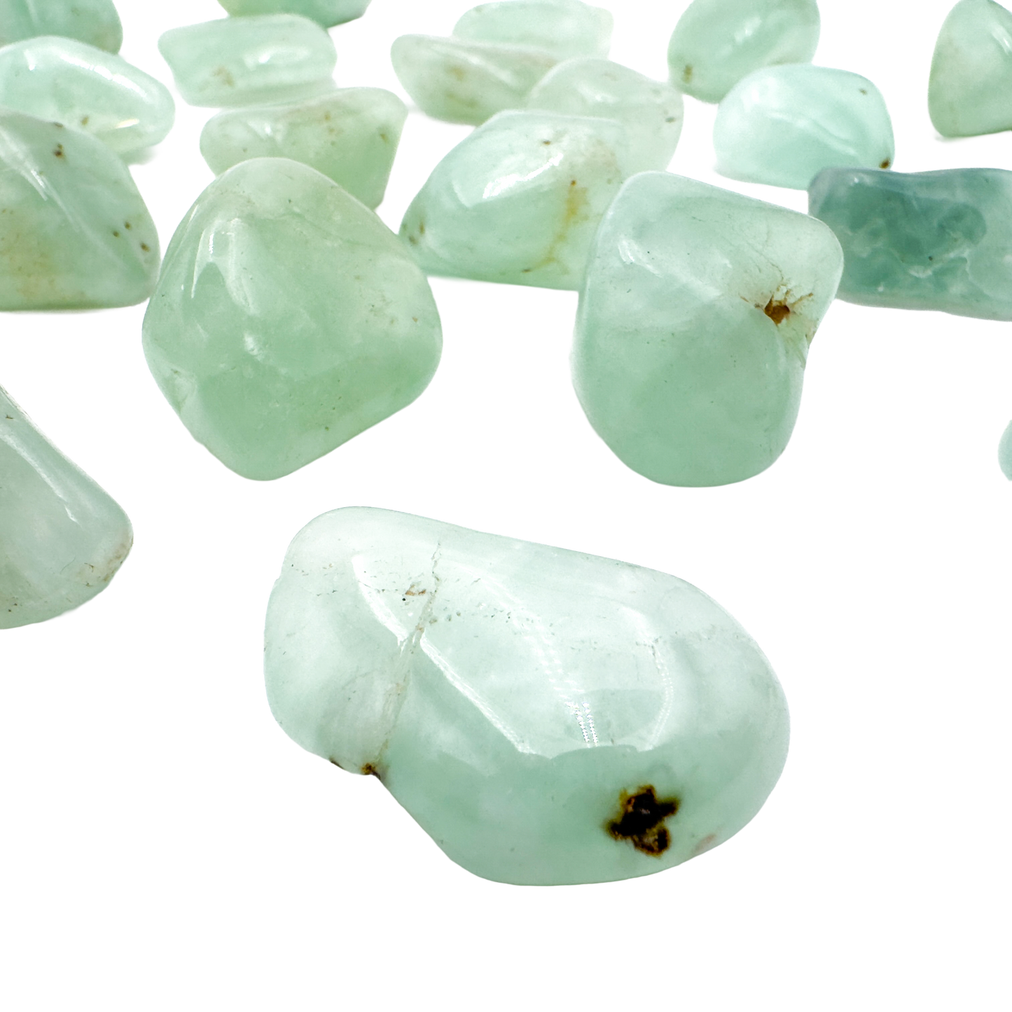 Close grouping of Prehnite tumbled pieces (1-1.50 Inch, 10-30g) showing pale green to yellow-green color range
