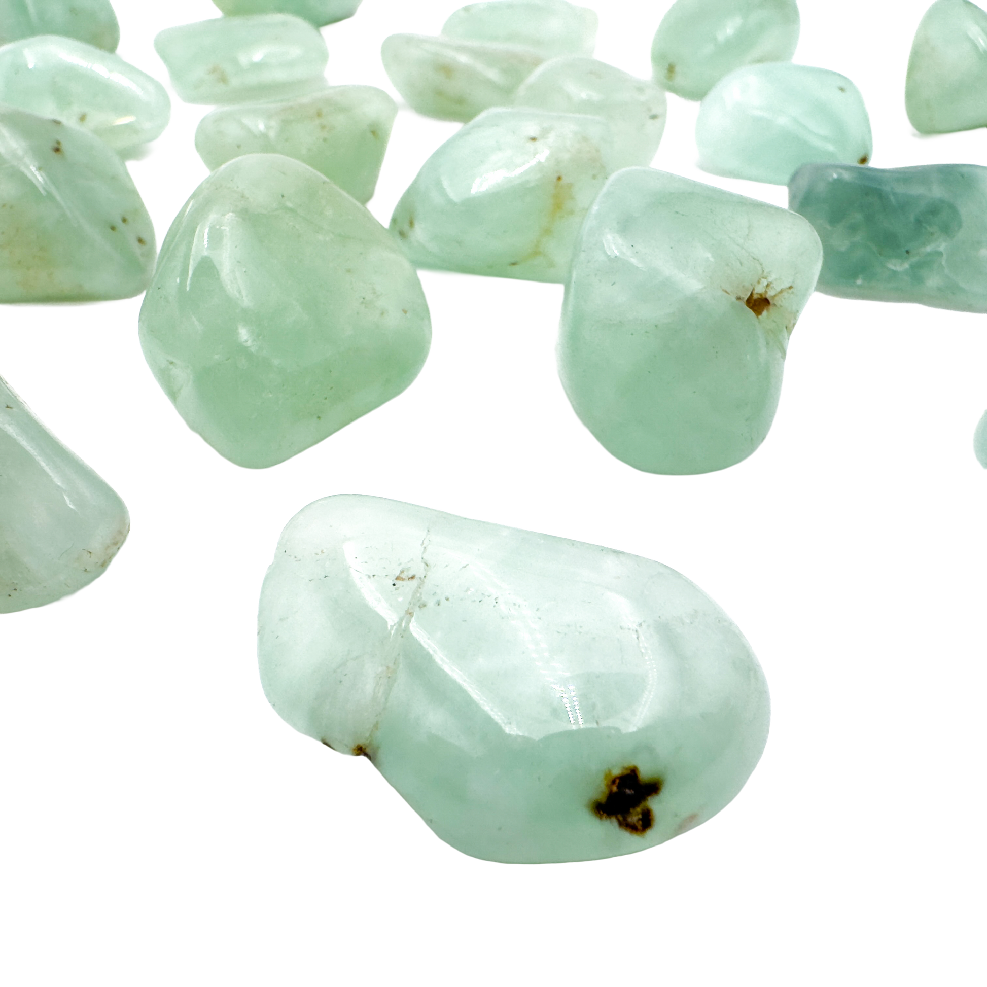 Close grouping of Prehnite tumbled pieces (1-1.50 Inch, 10-30g) showing pale green to yellow-green color range