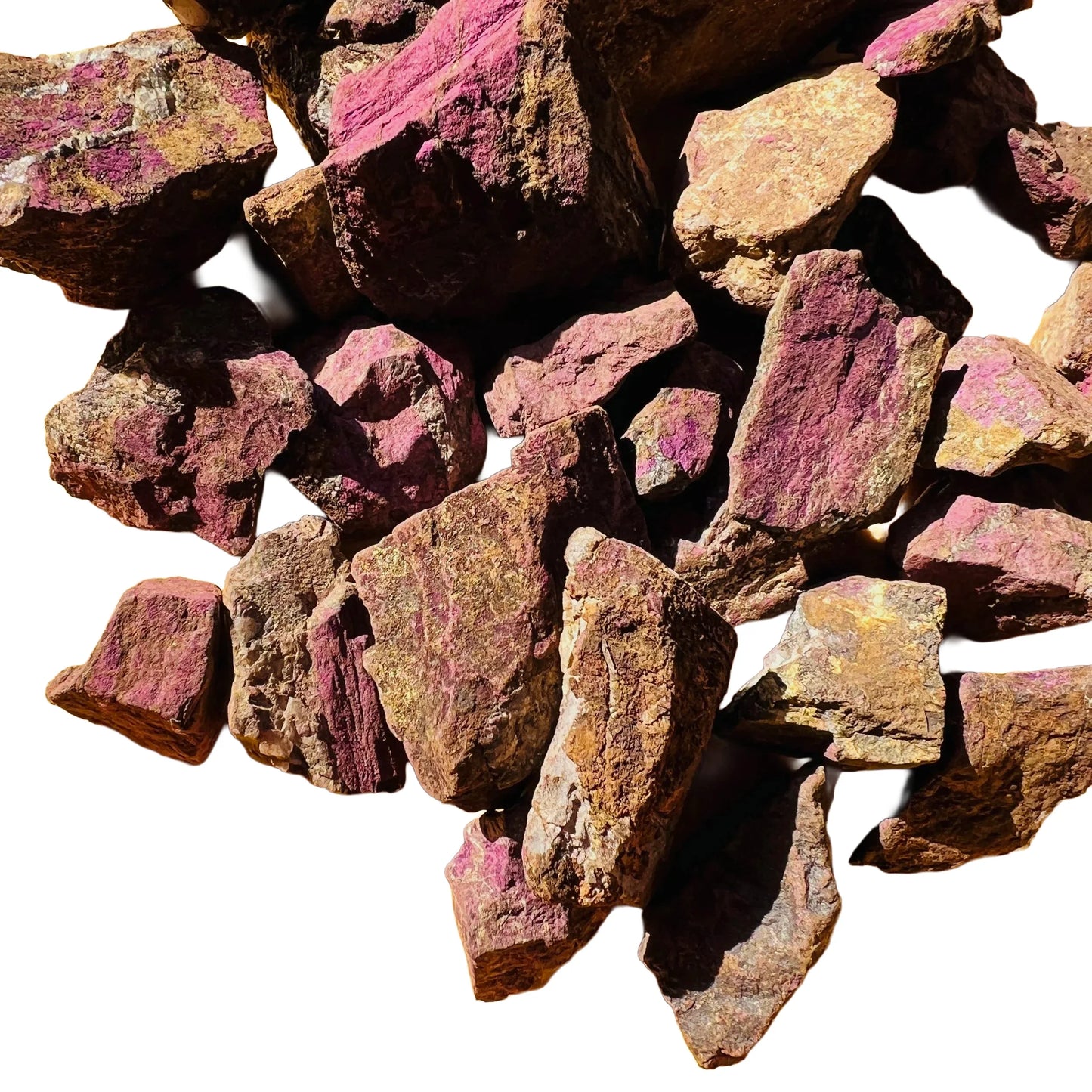 Held in hand, a Purpurite raw stone held against natural backdrop, sourced from Erongo, Namibia.