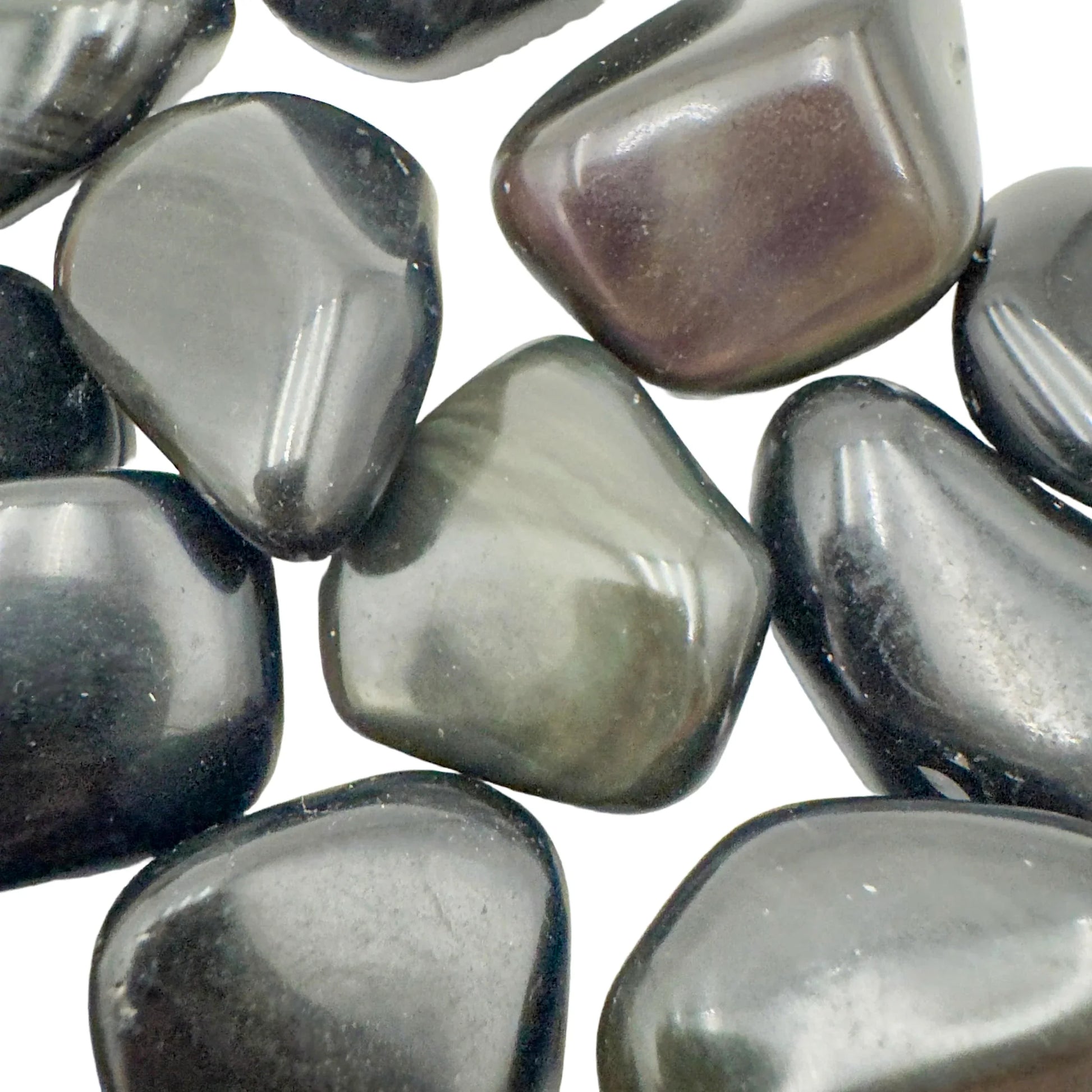 Edge view of Rainbow Obsidian tumbled stone, showing color depth.
