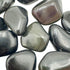 Edge view of Rainbow Obsidian tumbled stone, showing color depth.
